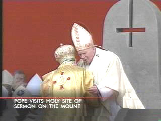 Invert Cross behind Blessed Pope John Paul II
