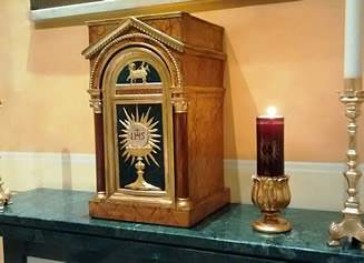 A Tabernacle with the Blessed Sacrament (the consecrated Host)
inside indicated by the red candle lit next to it.